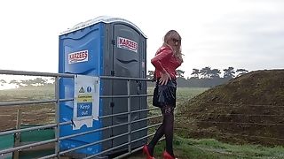 Pvc Wearing Tranny Outdoors Posing And Pissing